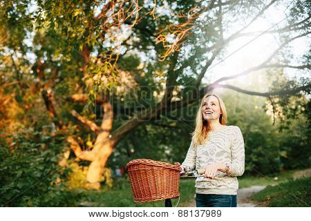 Young Blonde Woman On A Vintage Bicycle