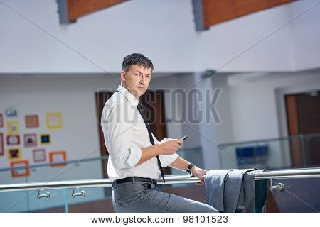 business man using phone at modern office space