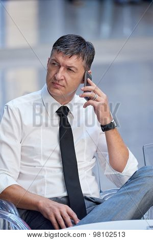 business man using phone at modern office space