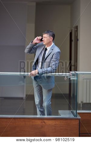 business man using phone at modern office space