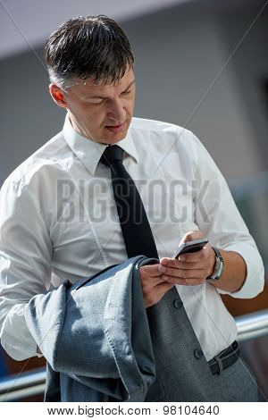 business man using phone at modern office space