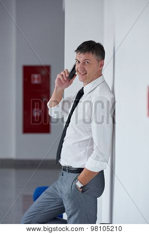 business man using phone at modern office space