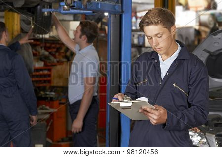 Apprentice Mechanic Working In Auto Repair Shop