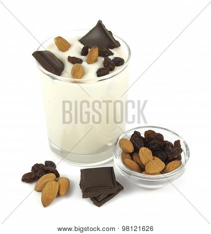 Healthy breakfast. Yogurt desert with chocolate, almond and raisins isolated on white background