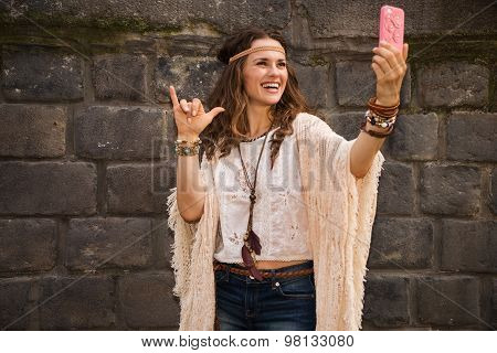 Happy Boho Young Woman Near Stone Wall Making Selfie