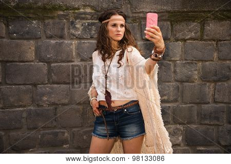Bohemian Young Woman Near Stone Wall Making Selfie