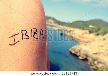 closeup of the arm of a young man with the word Ibiza written in it, in the southern coast of Ibiza Island, in Spain, in the Mediterranean sea