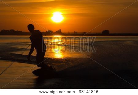 Wakeboarder Making Tricks On Sunset