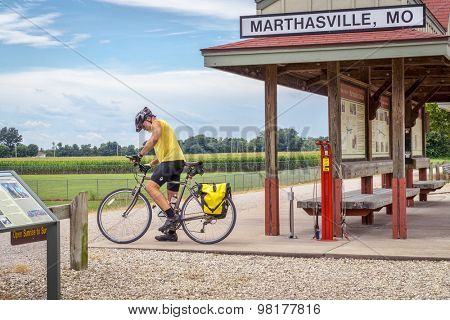 MARHTSVILLE, MO, USA - AUGUST 1, 2015: A touring cyclist at Marthasville stop on Katy Trail (237 mile bike trail stretching across most of the state of Missouri converted from abandoned railroad)