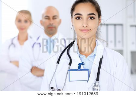 Happy doctor woman with medical staff at the hospital.