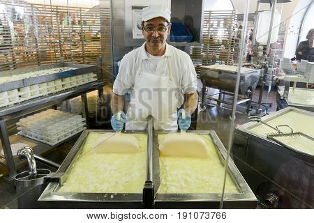 Cheesemaker Preparing The Cheese In A Show Dairy At Engelberg
