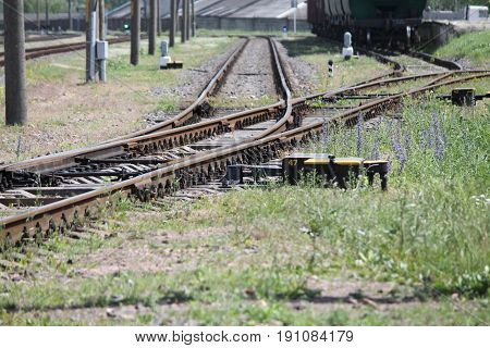 steel rails on road cross and tie lead in different direction