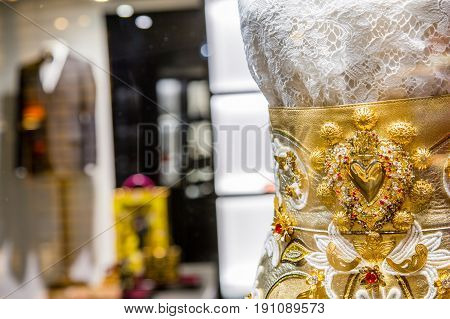 Italy, Venice - March 21, 2015: Luxury Store With Elegant Gold Dress And Suit On Background