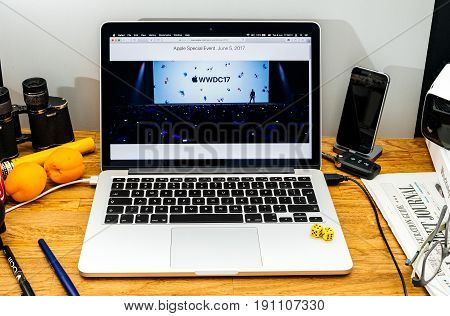 PARIS FRANCE - JUNE 6 2017: Apple Computers website on MacBook Retina in creative environment showcasing Tim Cook welcomes developers from 75 different countries WWDC 2017