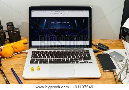 PARIS FRANCE - JUNE 6 2017: Apple Computers website on MacBook Retina in creative environment showcasing Tim Cook welcomes developers from 75 different countries WWDC 2017