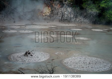 Mud texture or wet dark soil as natural organic clay and geological sediment mixture. Boiling hot mud in Waitapu, North Island in New Zealand.