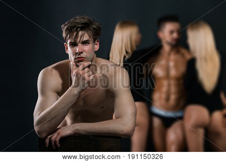 Thoughtful Man With Bare Chest Near Guy And Women