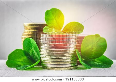 Stacks Of Russian Coins With Clover Leaves On A Gray Background With Droplets Of Water. St.patrick '
