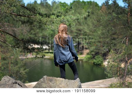 Women on quarry with water in the forest in details