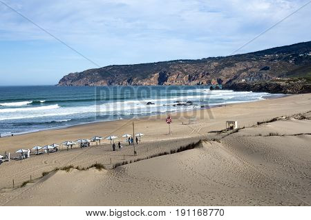 GUINCHO, PORTUGAL - SEPTEMBER 22, 2016: End of summer with a few people enjoying the surf at the Guincho Beach near Lisbon Portugal.