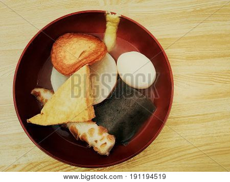 Oden with hot soup on wooden table, Japanese food.
