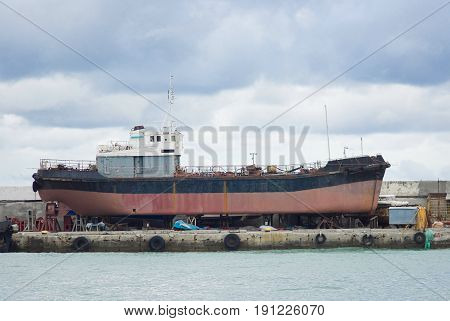 An old ship in a graving dock in Yalta port Crimea Ukraine.