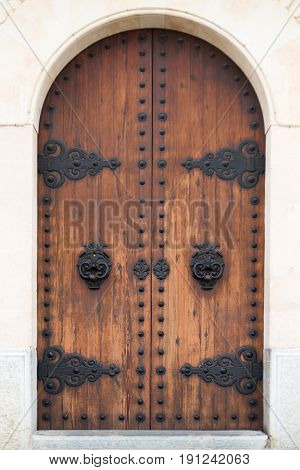 Old wooden door in a house made of marbel