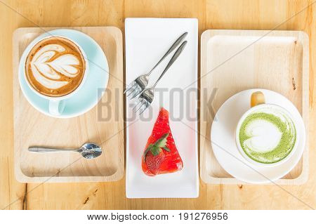 green tea milk latte cup and cake strawberry tasty on wood table in coffee shop
