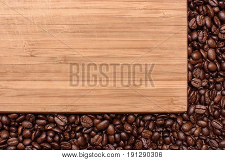 A Wooden Background Around The Edges Sprinkled With Roasted Grain Coffee, Space For Text