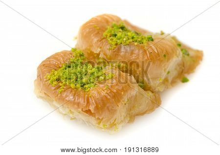 Baklava on the plate with pistachio on a white background