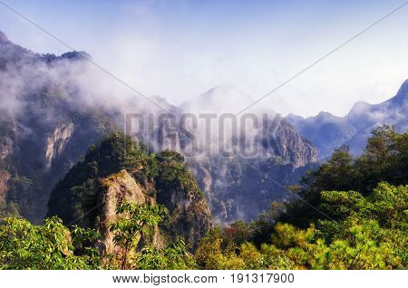 A low hanging cloud against blue sky in the early morning at Fangdong Scenic Area on Yandangshan mountains located in Zhejiang province China.