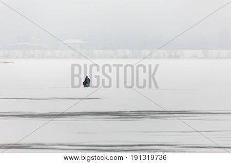 Winter fishing on the Volga river in Saratov. On the horizon is the city of Engels. Russia