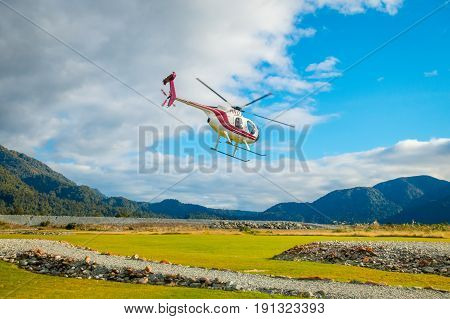 SOUTH ISLAND, NEW ZEALAND- MAY 25, 2017: A helicopter lifting off ready to take tourists to a glacier in the South Island of New Zealan.