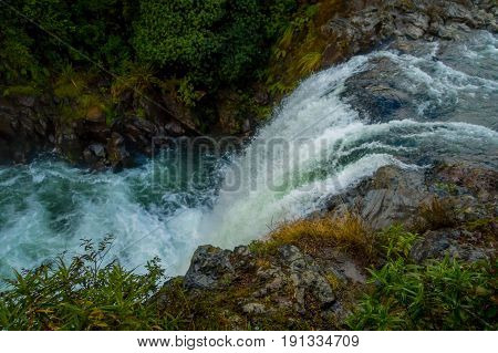 Water from volcano Mt Ruapehu forms Tawhai Falls in Tongariro National Park, New Zealand, lateral view.