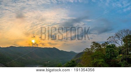 sunrise above mountain at Vajiralongkorn dam.many high mountains are standing around Vajiralongkorn dam beside the shore have resorts, bungalows and ralf for service tourists