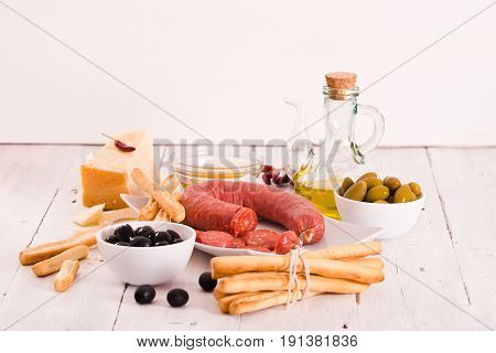 Grissini breadsticks with salami and parmesan cheese.