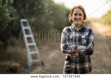 Portrait of smiling female standing at farm