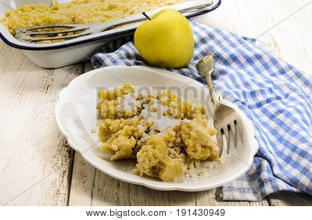 warm british apple crumble freshly baked served with powdered sugar on a plate