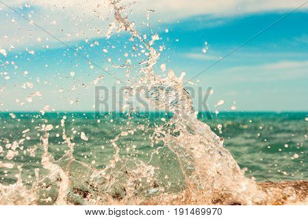 Breaking big waves sunlit sea foam in summer