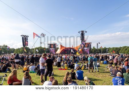 Roskilde, Denmark - June 30, 2016: Crowd of spectators enjoying a concert at the orange stage at Roskilde Festival 2016