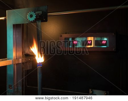 vertical burning test in second stage of physical property of polymer substance in standard laboratory or flamability of materials to classified of V0 V1 or V2.