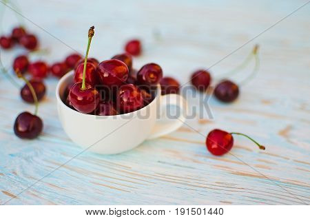 Red Ripe Cherry On A Background Of Trees