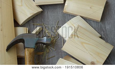 composition of boards, nails and hammer, hand hammer puts in the frame.