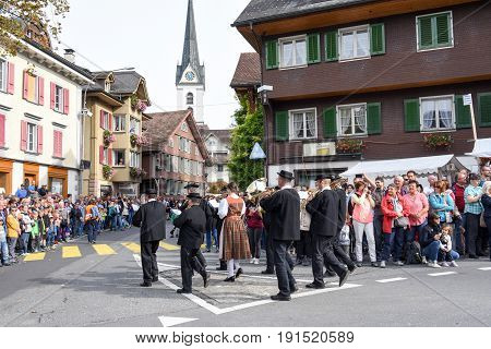 Kerns Switzerland - 1 October 2016: People wearing traditional clothes and playing the alphorn at Kerns on the Swiss alps