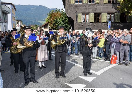 People Wearing Traditional Clothes And Playing Music Of Switzerland