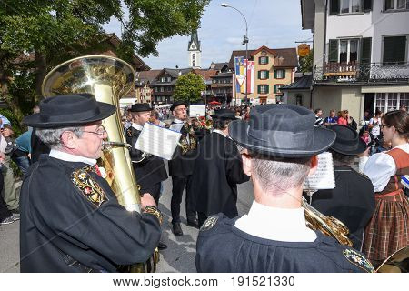 People Wearing Traditional Clothes And Playing Music Of Switzerland