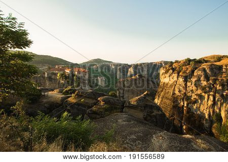 First sun rays on the Holy Monastery of Varlaam on the edge of high rock. Kalambaka, Greece.