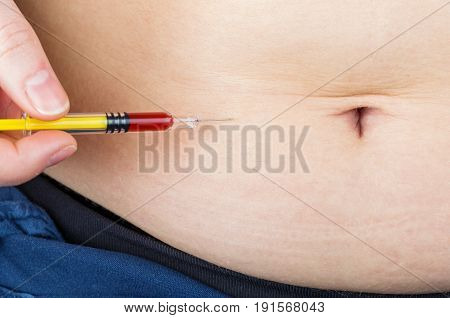 Close up photo of abdominal insulin injection