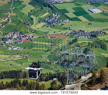 Mt. Stanserhorn, Switzerland - 7 May, 2016: people in a gondola of the Stanserhorn Cabrio cable car. The Stanserhorn Cabrio is the the world's first double deck open top cable car, it carries 60 passengers per cabin with room for 30 on the open deck.