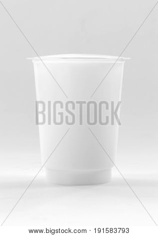blank packaging white plastic cup for yogurt dairy product on white background with clipping path